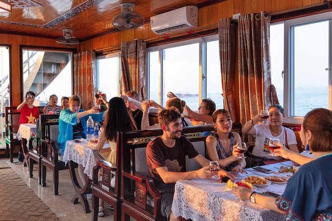 Halong Bay Day Tour With Titop Island, Cave, Kayak & Lunch - Kayaking or bamboo boating in the Hang Luon area