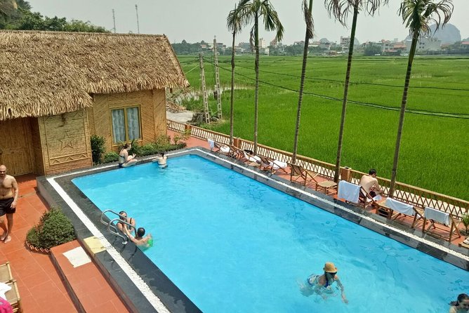 Ninh Binh Daily Tour: Hoa Lu -Mua Cave -Tam Coc- Bike-Swimming with Sunset Party - Tam Coc Sampan Ride: Slow Boat Time Through Limestone and Rice Fields